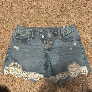 Girls denim shorts with a lace trim on the front of the bottom